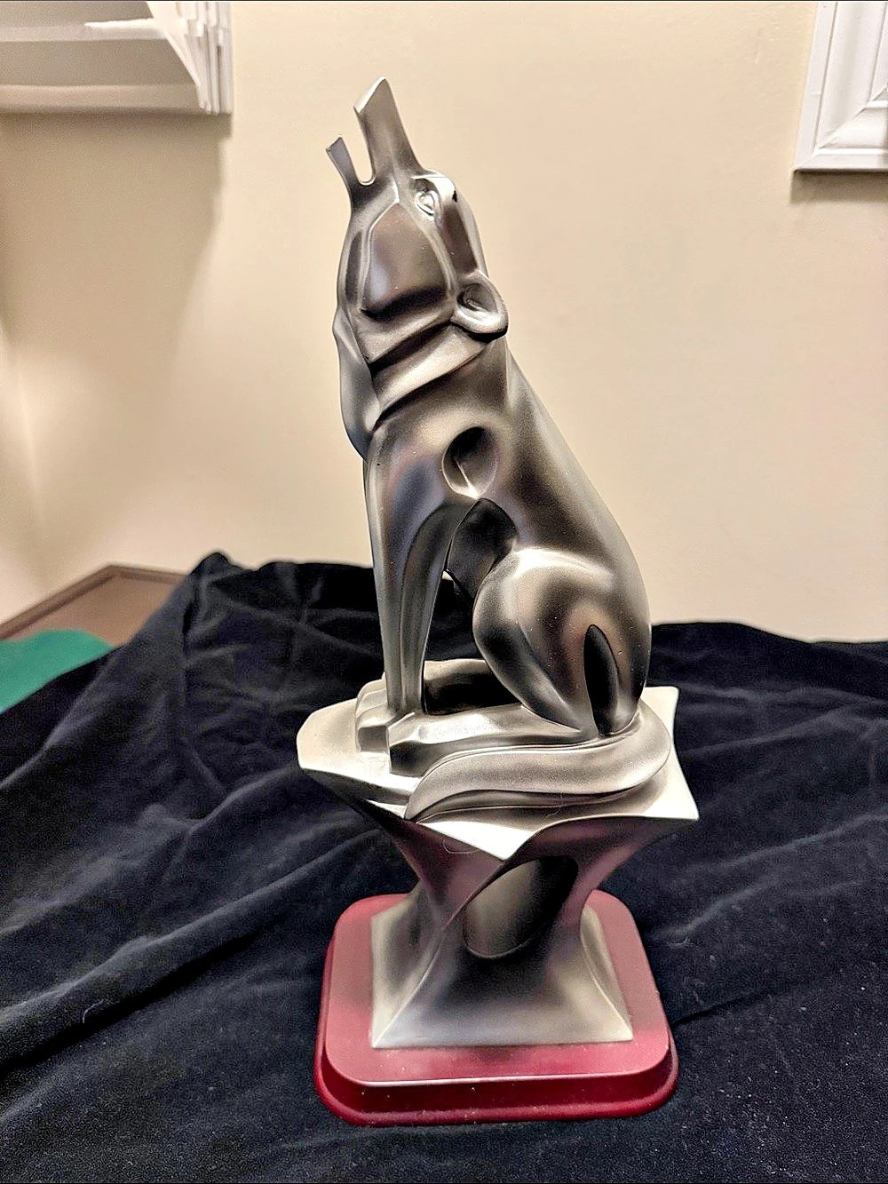 Art Deco style silver howling wolf sculpture. This specific line of retro-modern